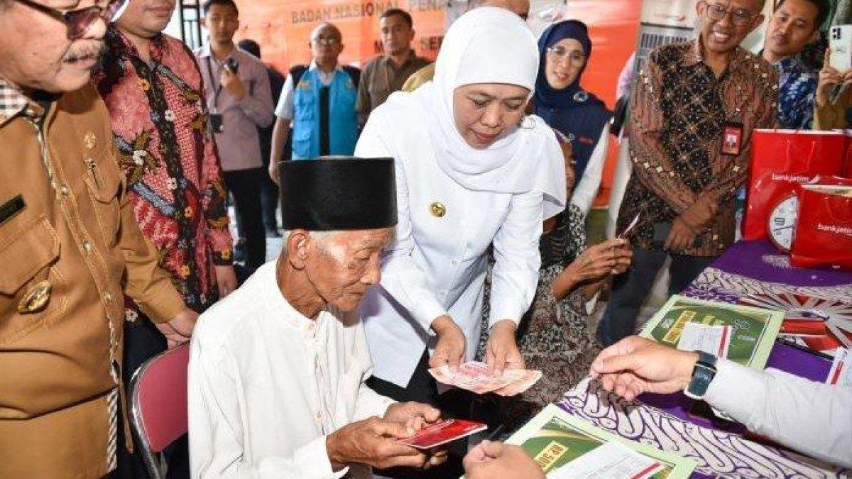 Gubernur Jawa Timur Khofifah Indar Parawansa saat menyalurkan Bansos bagi penerima manfaat PKH Lansia.