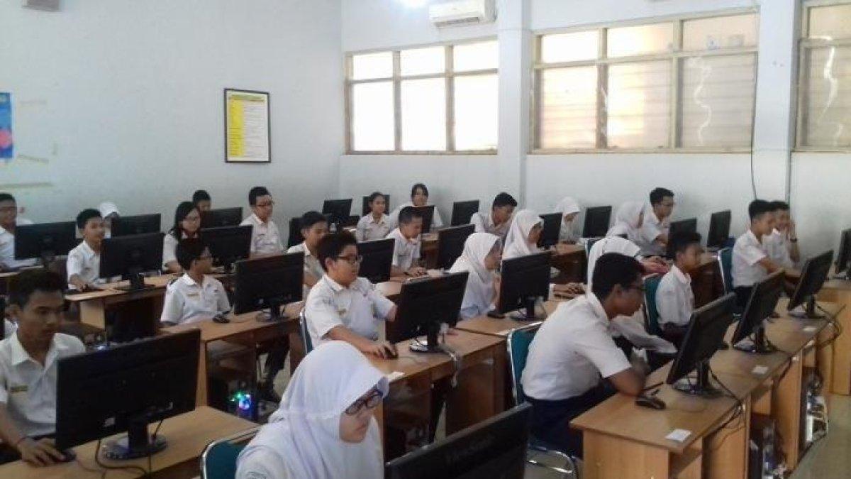 Ilustrasi siswa SMPN 1 Surakarta, Jawa Tengah pada saat mengikuti uji coba ujian nasional berbasis CBT di sekolah setempat.