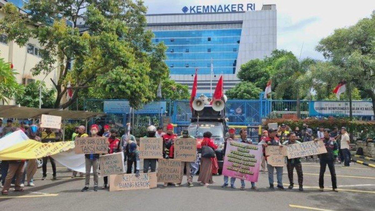 DEMO OJOL - Massa aksi dari sejumlah pengemudi ojek online atau ojol dari berbagai aplikasi mendatangi halaman kantor Kementerian Ketenagakerjaan Senin (17/2/2035). Mereka menuntut THR, sepakat off bid massal, hingga Wamenaker temui pada driver.
