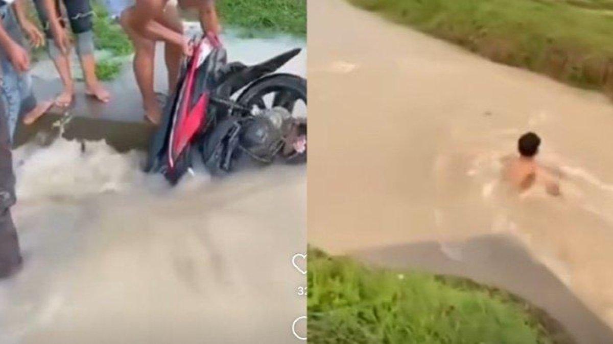 Motor berwarna merah hanyut terbawa arus