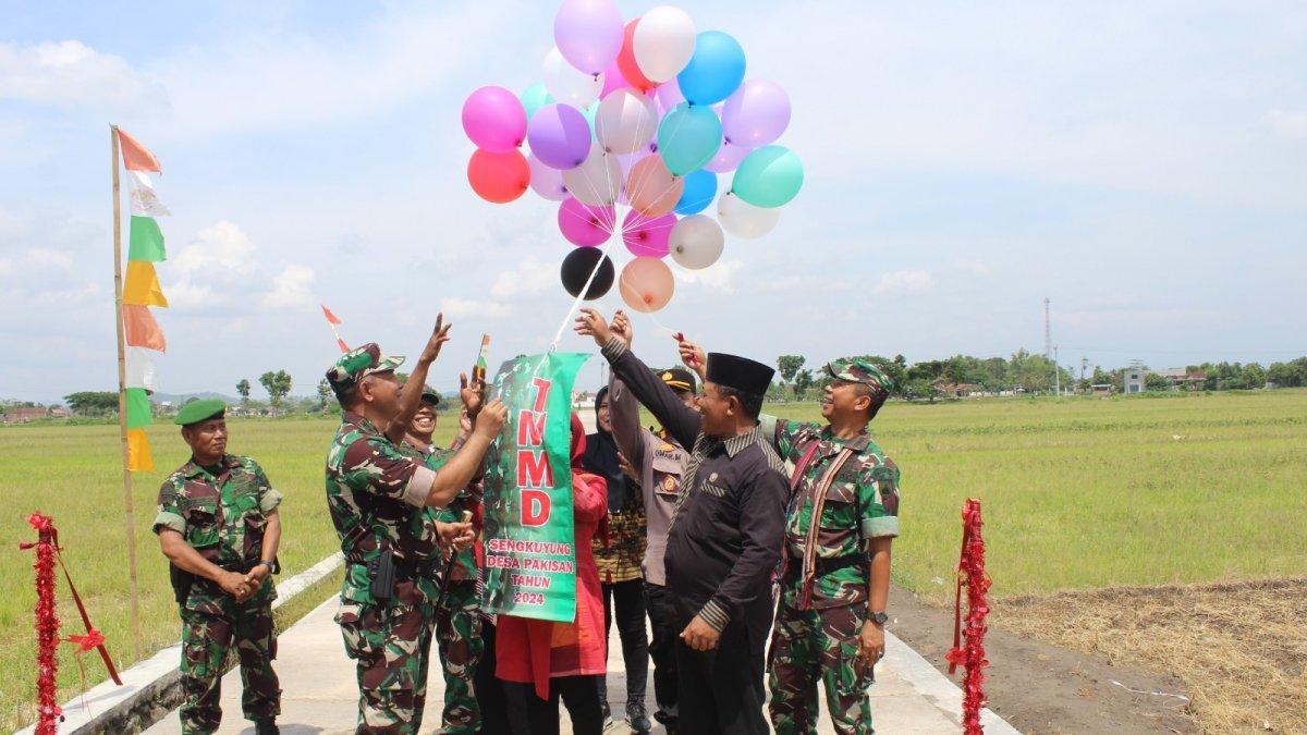 Pemotongan pita sebagai tanda peresmian jalan hasil sasaran fisik TMMD Sengkuyung Tahap IV Desa Pakisan, Kecamatan Cawas, Klaten Tahun Anggaran 2024 Dandim 0723 Klaten (kiri) dan Kepala Dispermasdes Klaten (batik merah) pada Kamis (31/10/2024).
