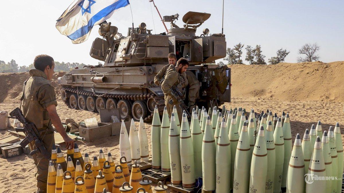 Personel artileri Israel menyiapkan peluru di dekat perbatasan dengan Jalur Gaza di Israel selatan pada 6 November 2023.
