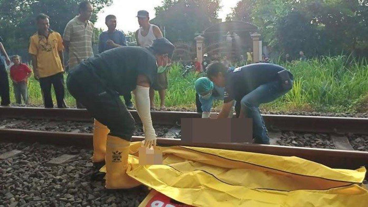 Petugas mengevakuasi jasad wanita yang tertabrak kereta di jalur kereta api Desa Ketanon, Kecamatan Kedungwaru, Kabupaten Tulungagung, Rabu (15/11/2023).