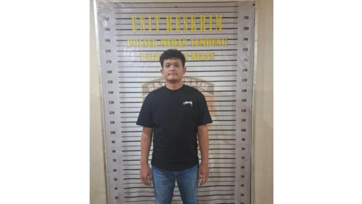 SOSOK PREMAN - Tampang Rio F.A Ginting (23), pria yang mengaku sebagai anak Kasat Narkoba Polrestabes Medan usai ditangkap, Jumat (25/7/2025). Ia sempat memeras pedagang kedai Aceh, sambil mengancam.