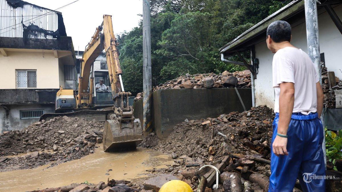 Warga Wu Hsuan-kai (kanan) melihat rumahnya yang rusak akibat tanah longsor akibat topan Kong-rey di Yilan pada tanggal 1 November 2024. (ARSIP, 2024)