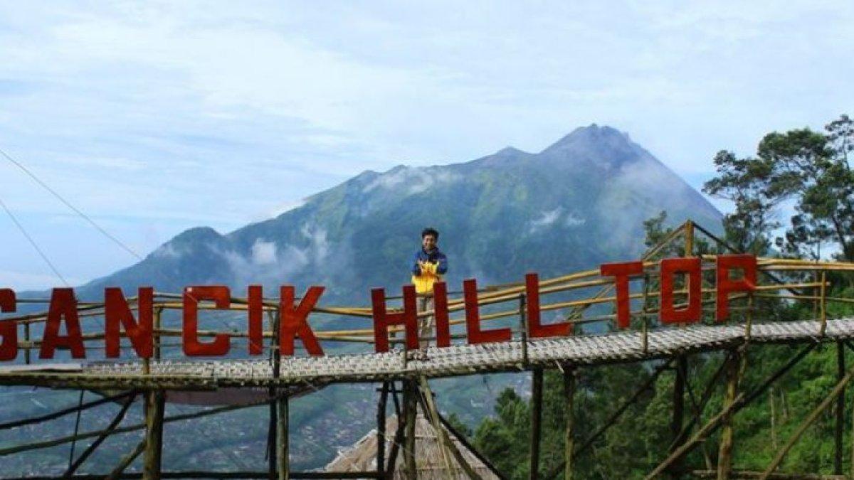 BUKIT GANCIK - Wisatawan berfoto di atas jembatan bambu berlatarkan Gunung Merbabu, di Wisata Gancik Hill Top, Selo, Boyolali.