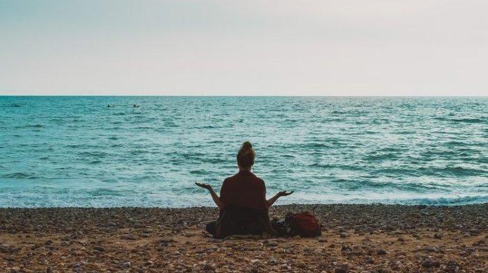 Ilustrasi meditasi di tepi pantai.