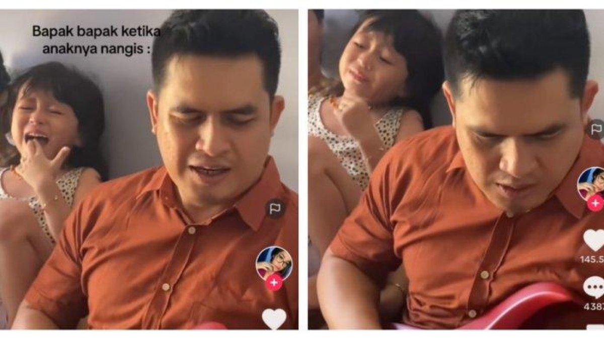 Seorang pria terlihat sedang memainkan gitar listrik saat anaknya menangis