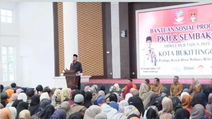 Wako Erman Safar saat menyerahkan bantuan sosial kepada masyarakat yang membutuhkan.
