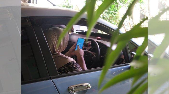 Jian Mardiah (24), melakukan aktivasi layanan Mobile Banking Bank Sumsel Babel (BSB), untuk mengecek saldo tabungan Pesirah-nya tanpa harus ke kantor atau ATM Bank Sumsel Babel lagi, Sabtu (29/6/2025).