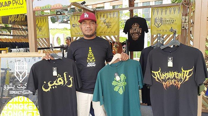 Owner Songket Yellow, Muhammad Fadly memperlihatkan sejumlah desain kaos produksi Songket Yellow yang sempat dipamerkan dalam ajang Kenduri Riau 2024 pada Oktober 2024 lalu. 