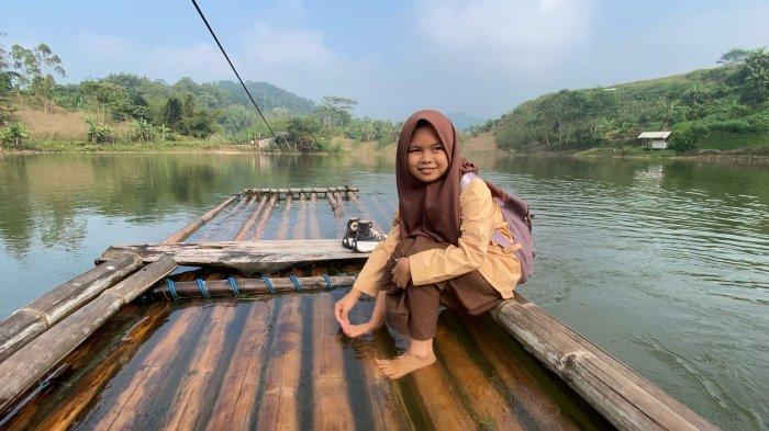 NAIK RAKIT - Nera Nur Puspista, Pelajar SMAN 1 Saguling, Kabupaten Bandung Barat (KBB) saat menyebrangi perairan Waduk Saguling dengan menaiki rakit untuk menuju ke sekolah, Rabu (14/5/2025).
