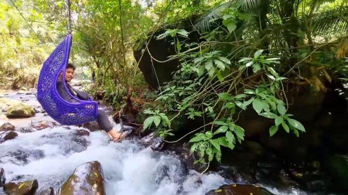 KERANJANG SULTAN - Wilujeng Sumping di Jembatan Gantung Lembah Purba. Tulisan besar berwarna putih berlatar cokelat kayu, terbaca di gerbang masuk saat kita menengadahkan mata di kawasan wisata Situ Gunung Sukabumi.