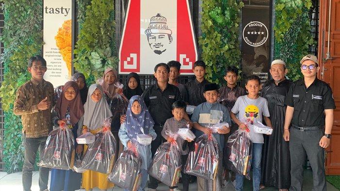 FOTO BERSAMA - Manajemen Kutaradja Fried Chicken foto bersama dengan anak-anak yatim usai menyerahkan bantuan berupa peralatan sekolah di Kutaradja Fried Chicken Office, Jalan Mr Dr Teuku Mohd Hasan, Blang Cut, Banda Aceh, pada Jumat (4/7/2025).