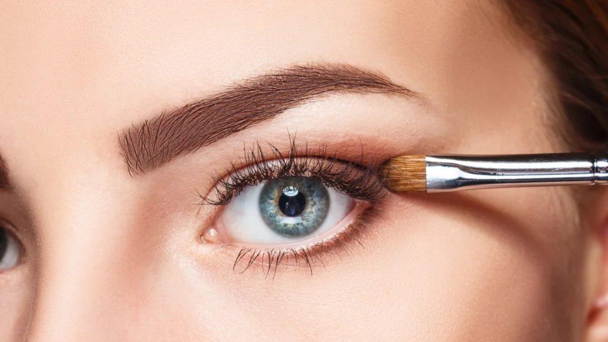 Ilustrasi wanita menggunakan eyeshadow warna nude.