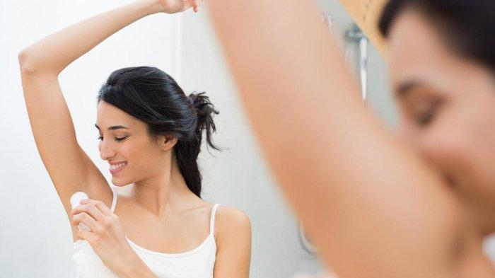 Ilustrasi wanita mengaplikasikan deodorant.