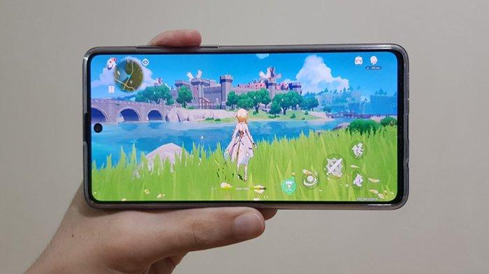 Ilustrasi HP dipakai main game Genshin Impact yang bertipe open world