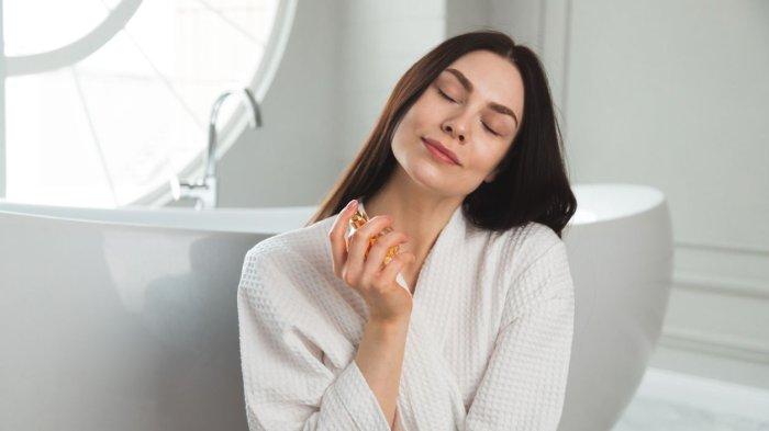 Ilustrasi menyemprotkan parfum.