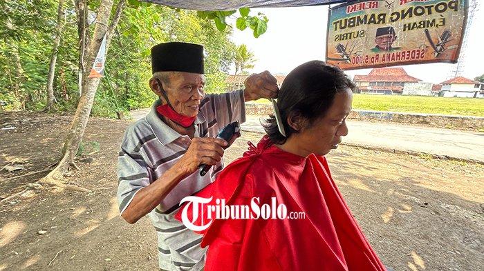 Mbah Sutris, tukang cukur di Lapangan Desa Lemah Miring, Desa Paseban, Kecamatan Bayat, Klaten.