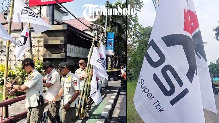 DICOPOT - Menjelang kongres, Bendera Partai Solidaritas Indonesia (PSI) dengan logo barunya dicabut oleh Satpol PP Kota Surakarta lantaran dipasang di white area, Rabu (16/7/2025). Di area ini reklame dalam bentuk apa pun dilarang.
