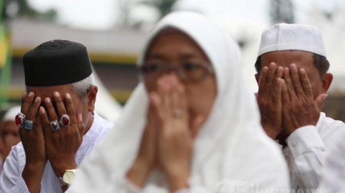 JEMAAH BERDOA - Sejumlah jamaah melaksanakan doa dan zikir bersama di Lapangan Merdeka, Medan, Sumatera Utara, Rabu (31/12/2014). (TRIBUN MEDAN/RISKI CAHYADI)