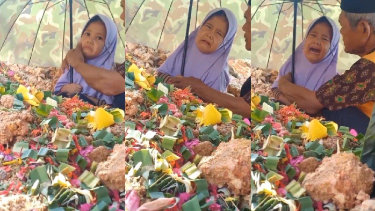 Bocah tak mau beranjak dari makam sang ayah meski sudah dibujuk kakeknya
