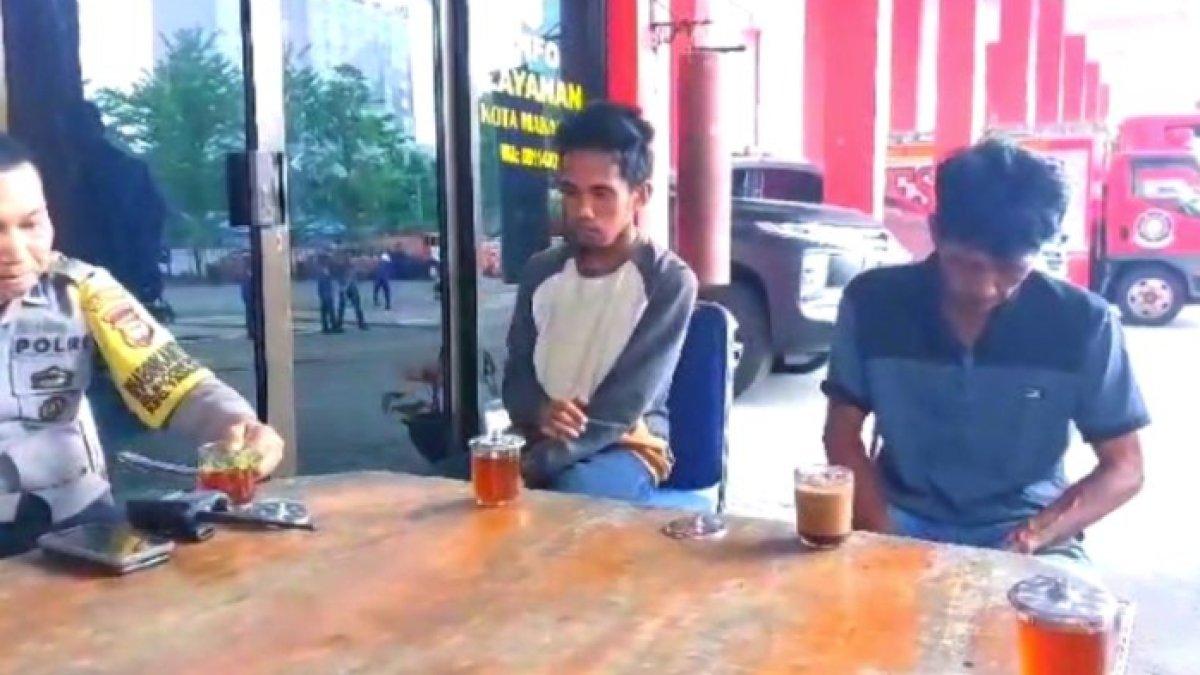 Buruh bangunan yakni MNH yang diamankan di kantor Damkar Makassar usai membuat laporan palsu peristiwa kebakaran didampingi petugas kepolisian dan orangtuanya