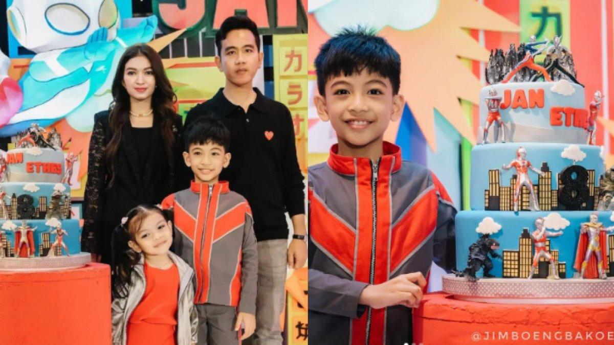 Jan Ethers memakai kostum bernuansa merah dan abu-abu.