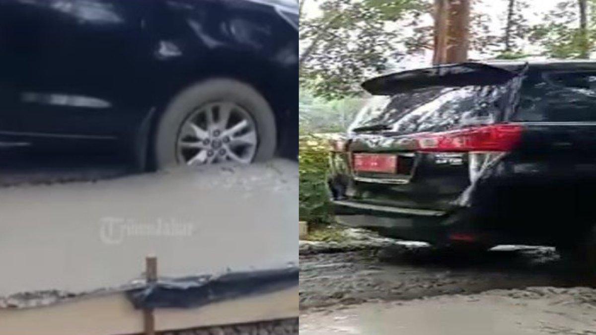 Mobil dinas di Sumsel santai melindas jalan yang masih basah baru disemen.