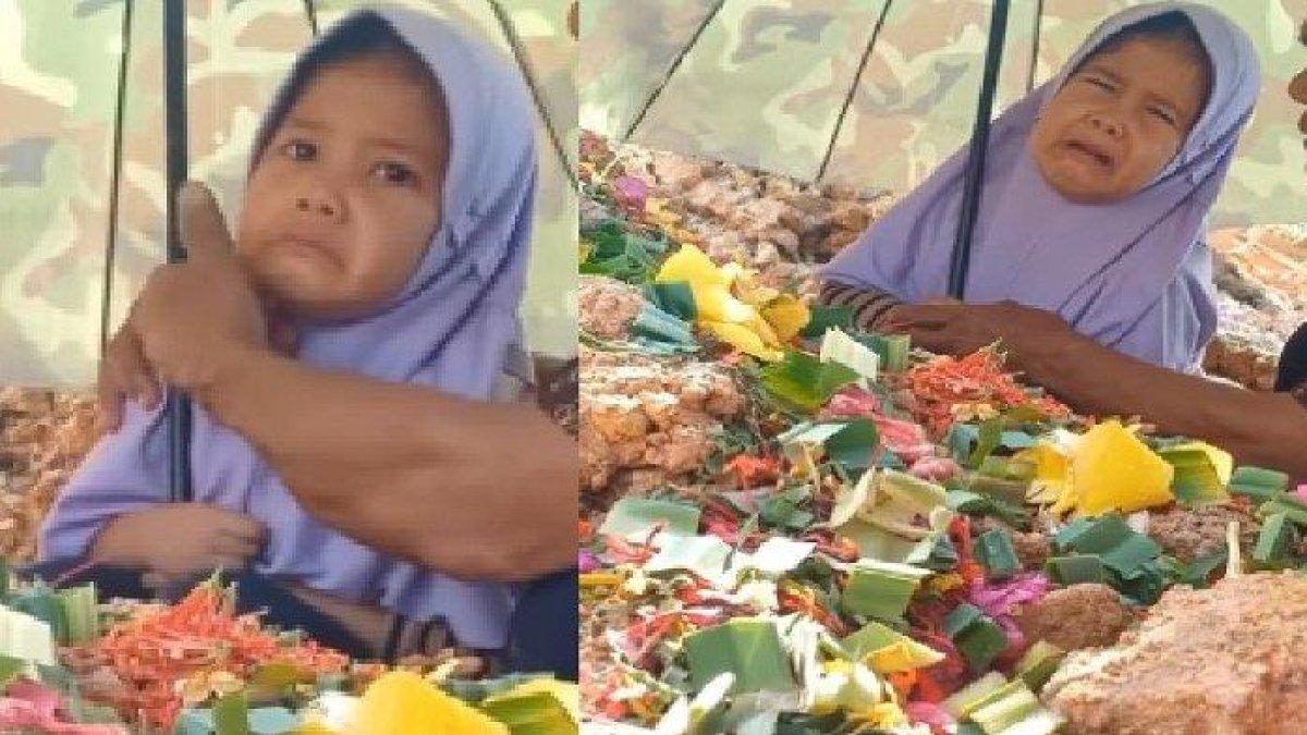 Momen haru seorang anak perempuan menangis gegara tak ingin pulang dari makam ayahnya