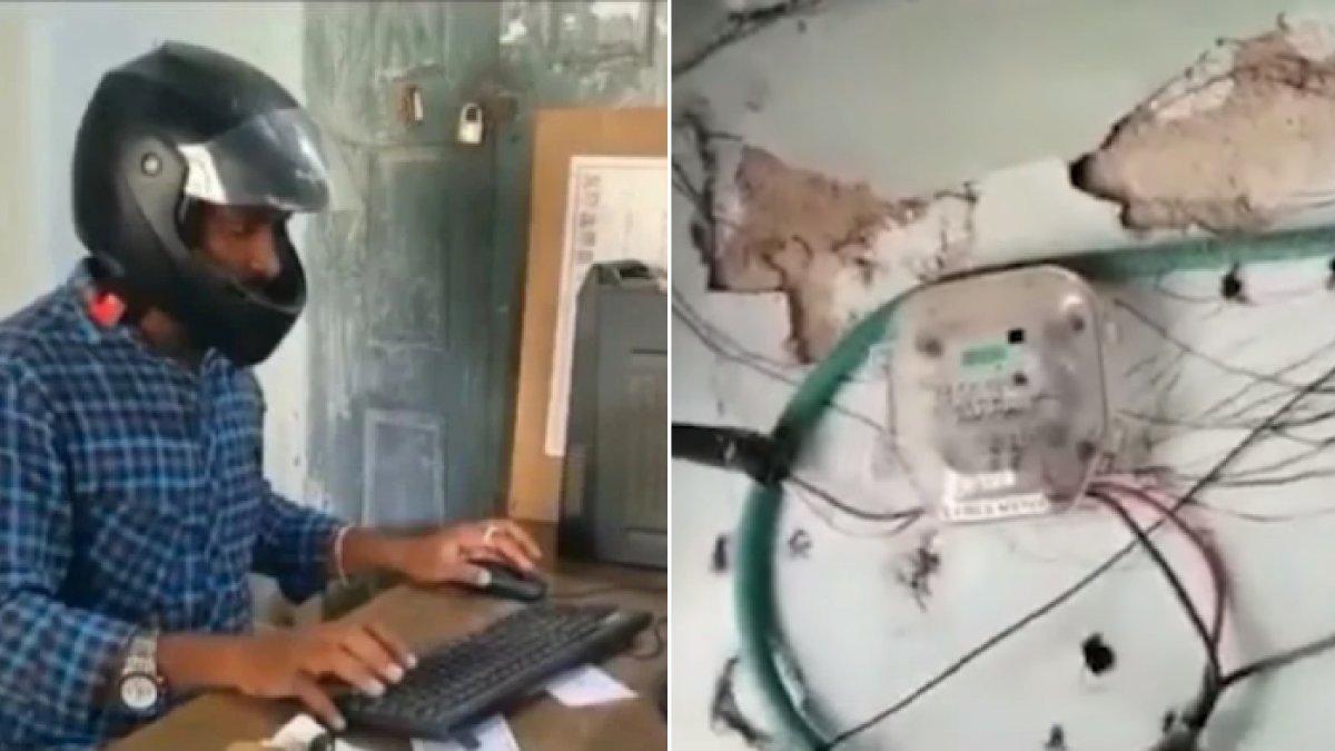 Pegawai pemerintahan di India memakai helm di kantor karena takut kejatuhan atap yang bobrok.