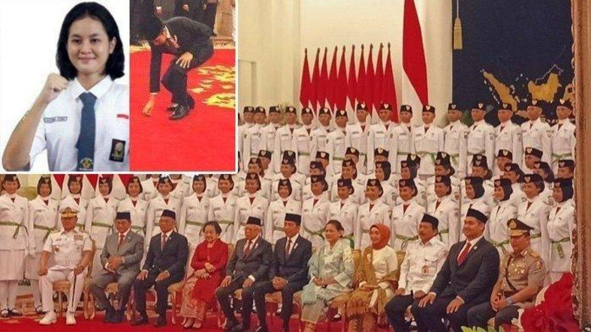 Presiden Joko Widodo saat berjongkok mengambilkan pin pengukuhan paskibraka yang terjatuh di Istana Negara, Jakarta, Selasa (15/8/2023)