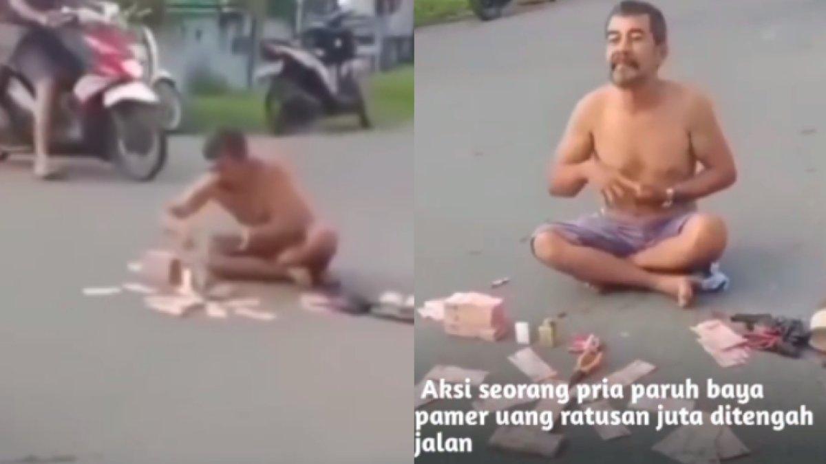 Pria pamer uang di tengah jalan