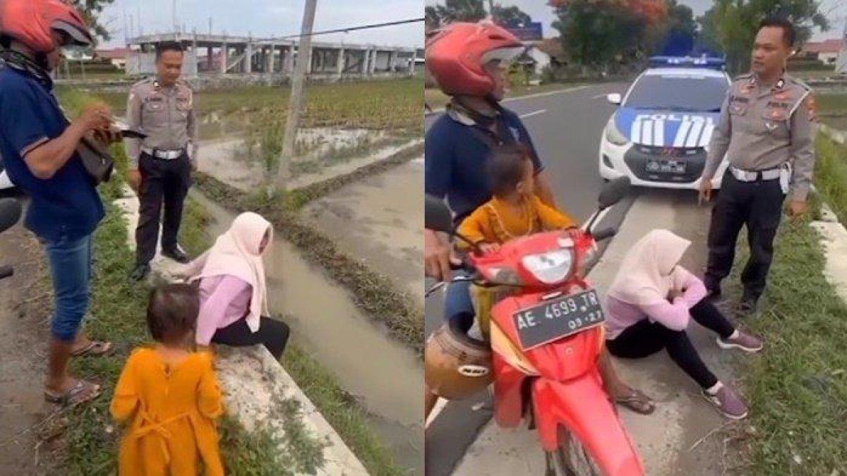 Sebuah video memperlihatkan pasangan suami istri tengah berselisih, istri menangis merengek-rengek duduk di aspal pinggir jalan