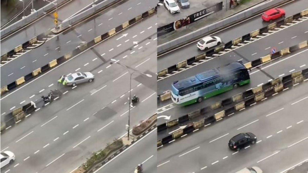 Seorang driver Grab membersihkan saluran air