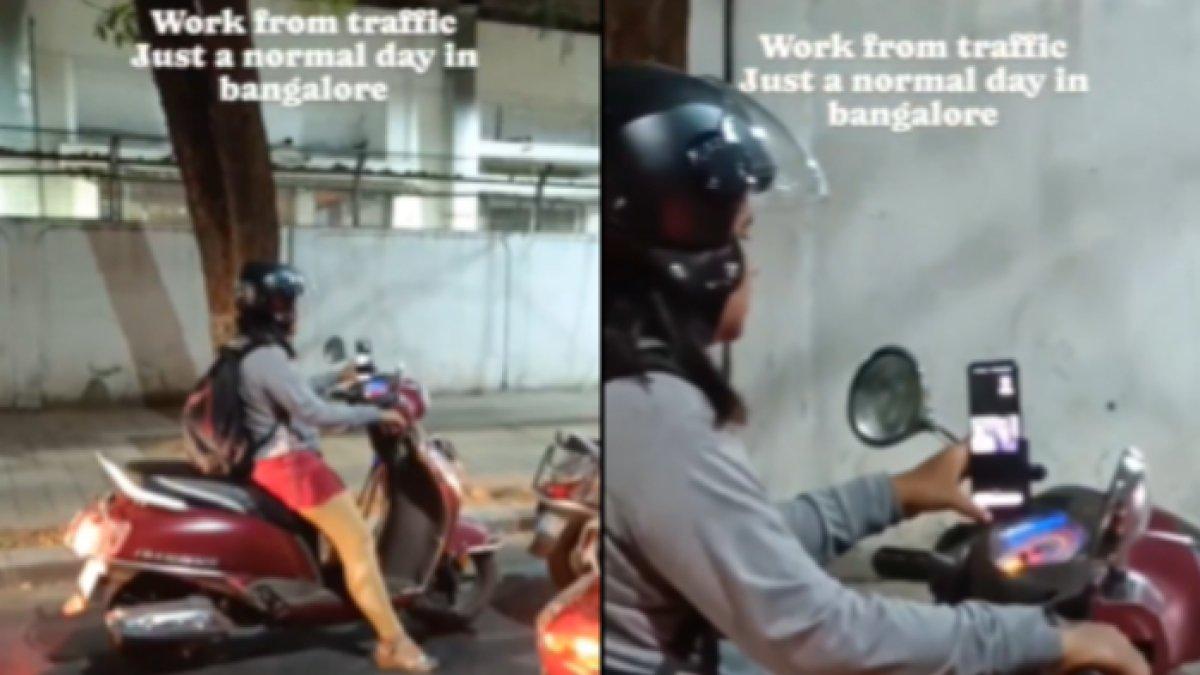 Seorang wanita di Bengaluru, India tetap kerja di tengah kemacetan