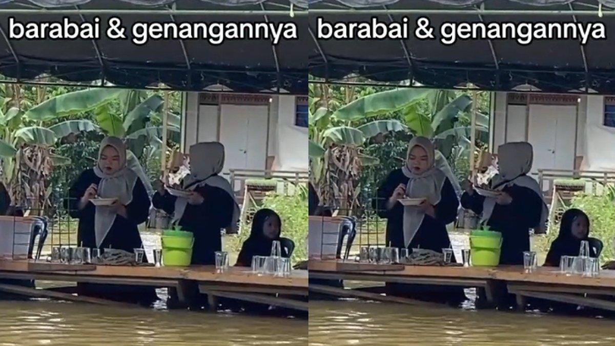 Tamu undangan asyik menyantap jamuan di pesta pernikahan walau diterjang banjir