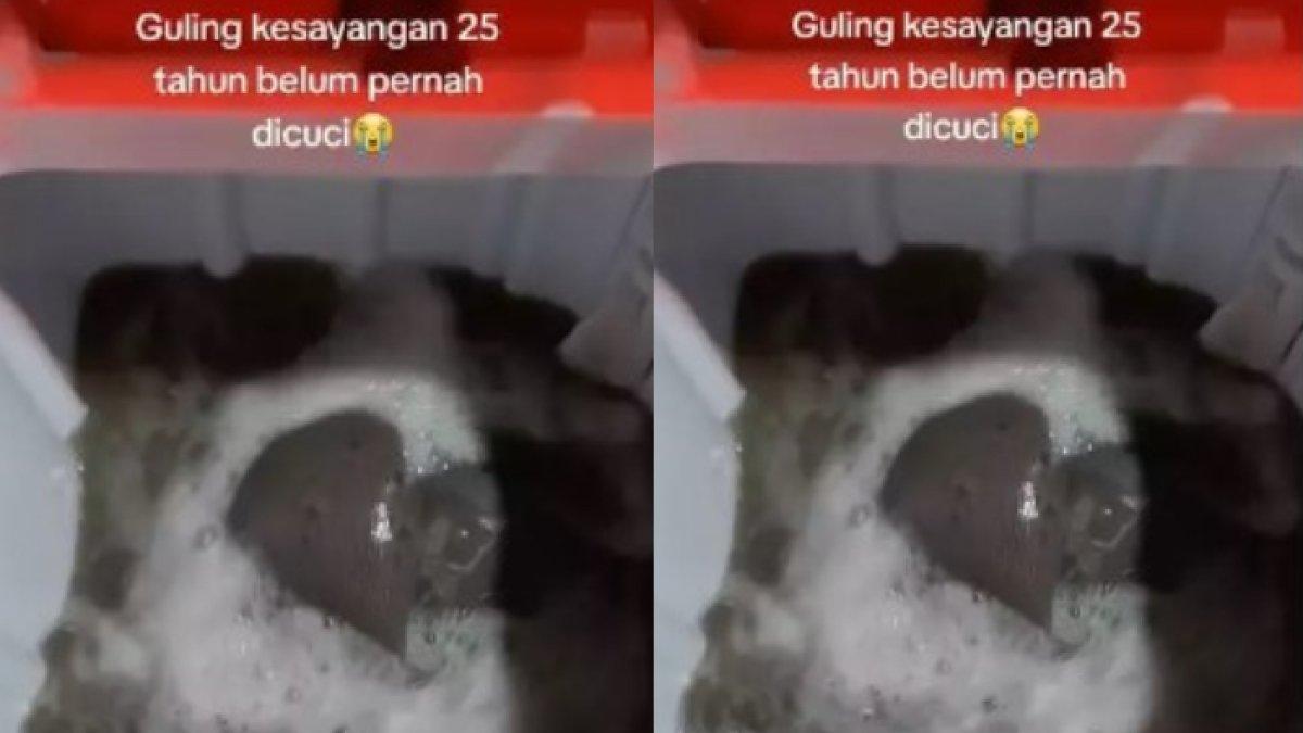 Terlihat guling dalam mesin cuci itu berwarna abu-abu hampir kehitaman.