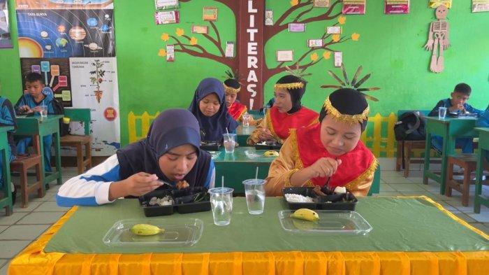 MAKAN BERGIZI GRATIS - Sejumlah pelajar SDN 26 Kendari tengah menyantap makan bergizi gratis (MBG) yang dibagikan oleh Pemerintah Kota (Pemkot) Kendari, Selasa (22/4/2025).