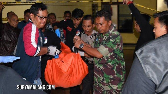 Petugas dari Kepolisian Polres Malang dibantu TNI mengevakuasi jenazah korban diduga perampokan dan pembunuhan di Desa Mangliawan Kecamatan Pakis, Kabupaten Malang, Jumat (22/3/2024). Satreskrim Polres Malang beserta Indonesia Automatic Fingerprint Identification System (Inafis) Polres Malang menyebut ada dua korban, satu meninggal dunia dengan luka di leher dan satu luka-luka dilarikan menuju rumah sakit setempat.