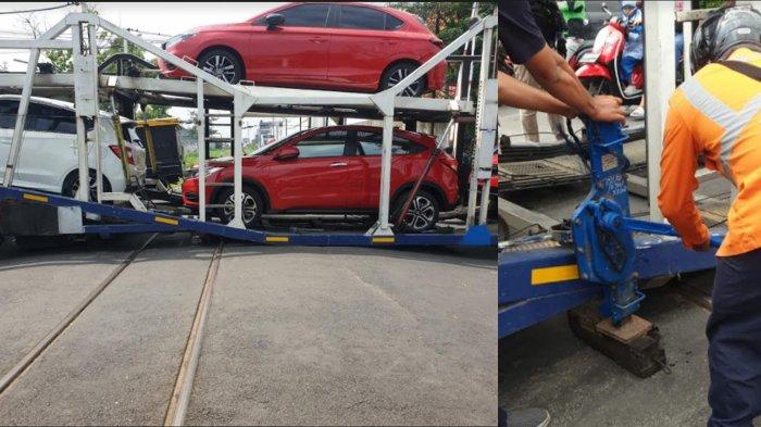 Kondisi truk pengangkut mobil baru yang tersangkut di perlintasan rel KA Jl Hasanudin, Kota Kediri dan Petugas berupaya dengan memasang dongkrak, Selasa (18/1/2022). 