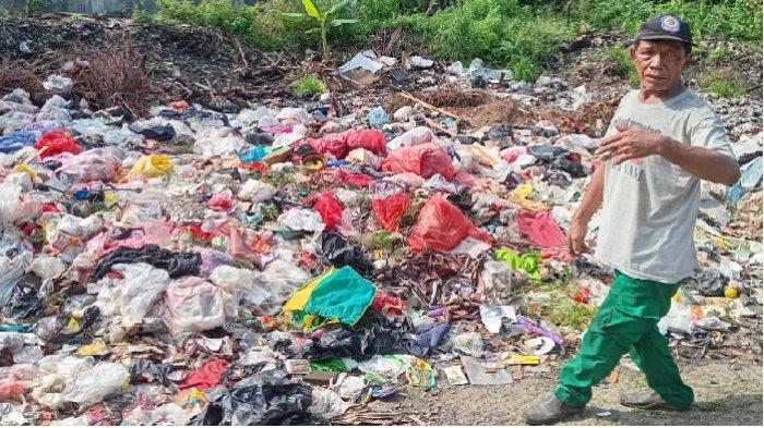 Dorti Siagian menunjukkan gunungan sampah di tempat pembuangan sampah (TPS) sementara Perumahan Departemen Keuangan, Jalan Jayawijaya, Kelurahan Karang Tengah, Kota Tangerang, Senin (15/4/2024). Tempat penampungan sampah itu tepat di depan rumah Dorti.