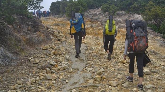 WISATA GARUT - Pendaki tengah melewati medan di awal pendakian Pos Camp David Gunung Papandayan, Garut, Jawa Barat, Minggu (21/2/2016) pagi. Medan yang dilalui didominasi oleh batuan beku dan belerang.