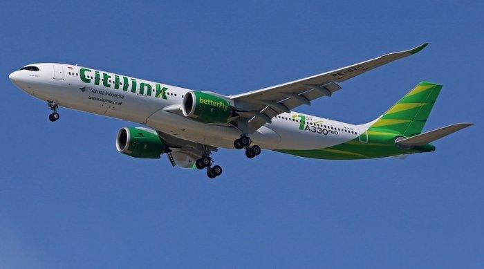 Ilustrasi maskapai Citilink yang sedang mengudara.