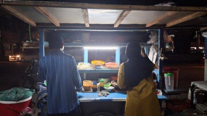 Muji (55) dan istrinya Supaa (50) pedagang makanan yang berlokasi tak jauh dari Patung Lengkong Wuaya, Kairagi, Kota Manado, Sulawesi Utara, Rabu (14/5/2025). Kepada Tribun Manado, Mas Muji menuturkan ia dan istri sudah berjualan sejak tahun 2003, artinya sudah sekitar 22 tahun.