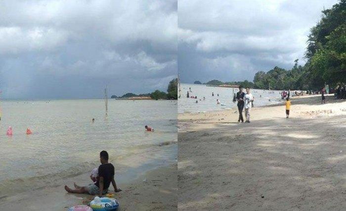 Pengunjung sedang menikmati bermain air di Pantai Tegar Bahari. Pantai ini termasuk destinasi wisata Batam yang menawarkan hamparan pasir putih.