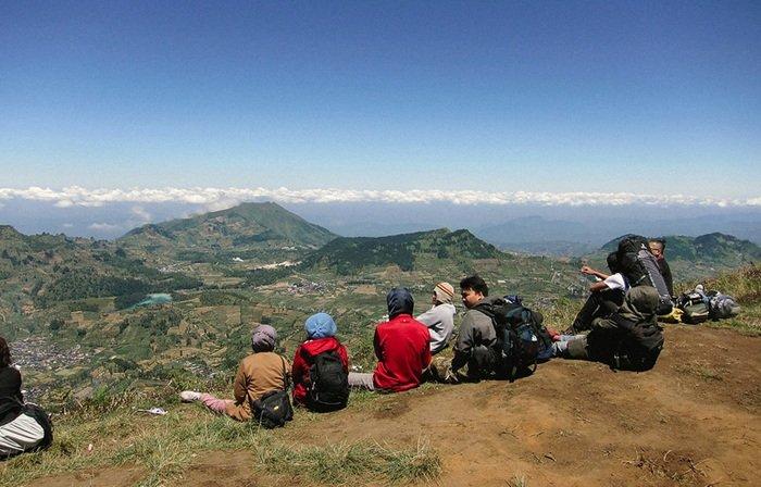 PUNCAK GUNUNG PRAU - Pendaki berfoto di Gunung Prau dengan latar belakang yang menawan, Jumat (21/2/2025).