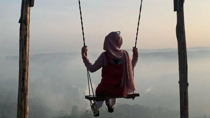 Pengunjung bermain wahana ayunan di Bukit Panyangrayan, tempat wisata hits di Tasikmalaya, Jawa Barat.