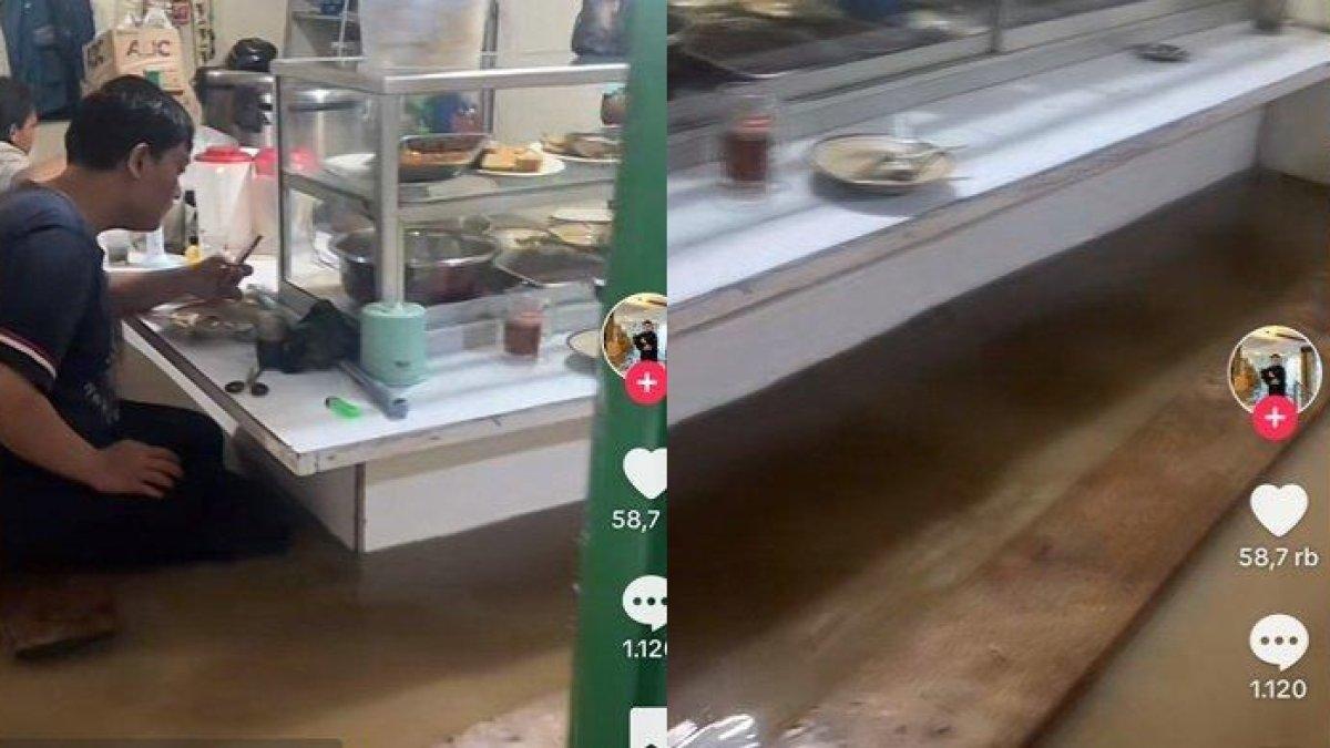 Warteg di Bandung tetap buka dan layani pembeli meski dilanda banjir, pelanggan asyik makan walapun dikepung air.