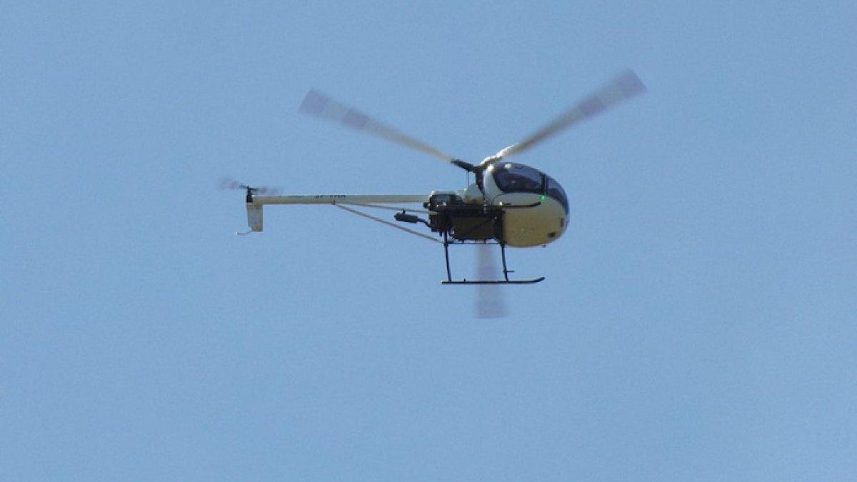 Ilustrasi helikopter yang sedang beroperasi di udara.